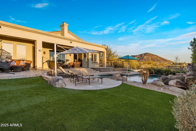 view of yard with a fenced in pool, a patio, a fire pit, and fence