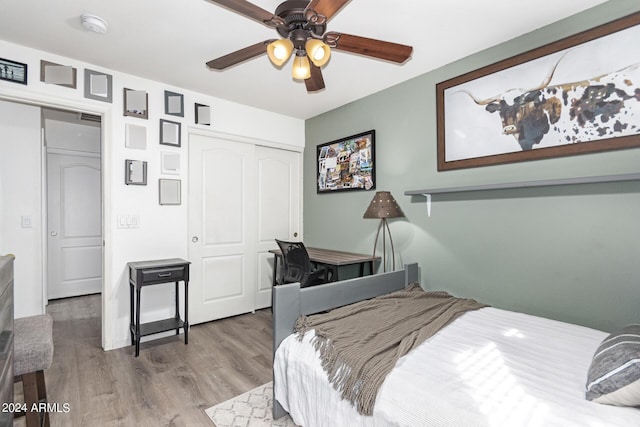 bedroom featuring hardwood / wood-style floors, ceiling fan, and a closet