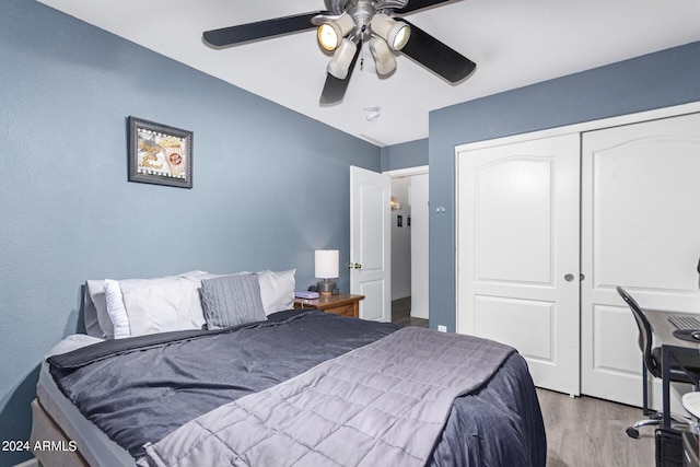 bedroom featuring a closet, ceiling fan, and light wood-type flooring