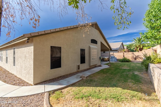 view of side of property featuring a yard