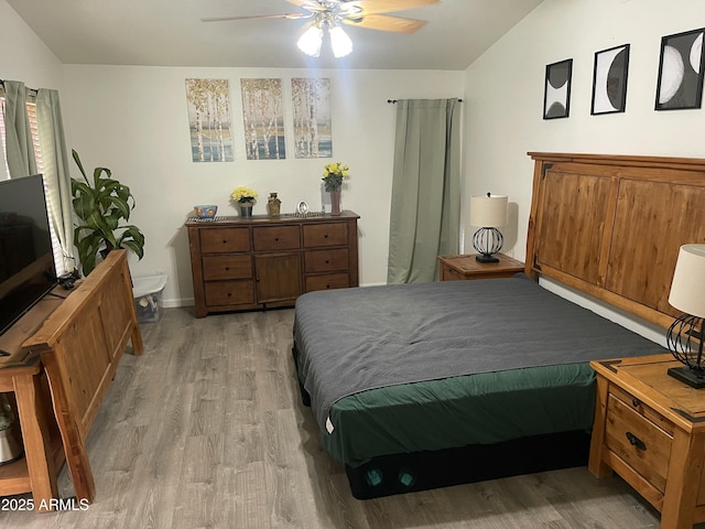 bedroom featuring ceiling fan, vaulted ceiling, and light hardwood / wood-style floors