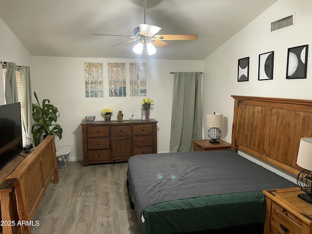 bedroom featuring lofted ceiling, ceiling fan, and light hardwood / wood-style flooring