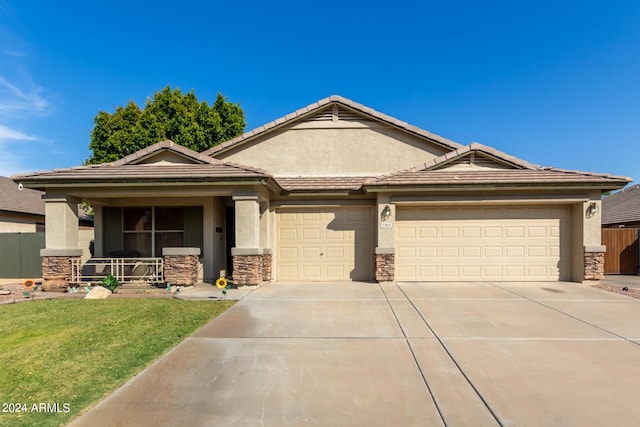 view of front of house with a garage, a porch, and a front lawn