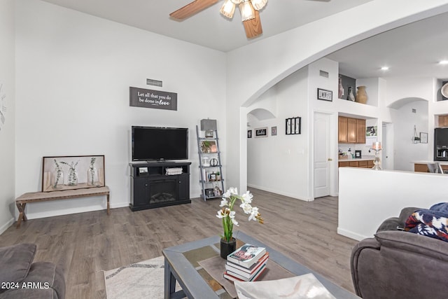 living room featuring hardwood / wood-style floors, a fireplace, and ceiling fan