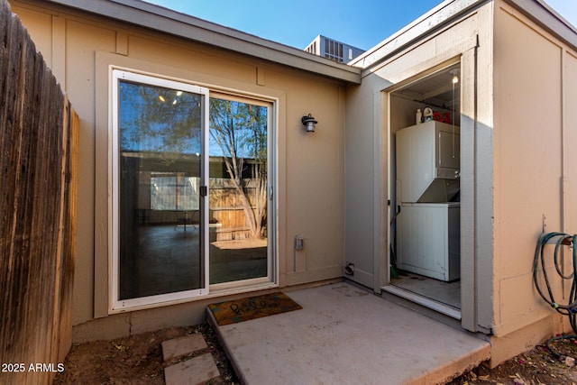 doorway to property with a patio and stacked washer / drying machine