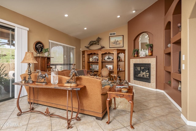 8698 E Preserve Way, Scottsdale, AZ 85266 - living area with plenty of natural light, built in shelves, lofted ceiling, a tile fireplace, and tile patterned flooring