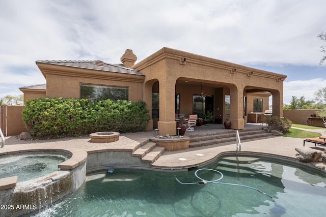 8698 E Preserve Way, Scottsdale, AZ 85266 - rear view of property with a patio area, an in-ground hot tub, an outdoor fire pit, a tiled roof, and stucco siding