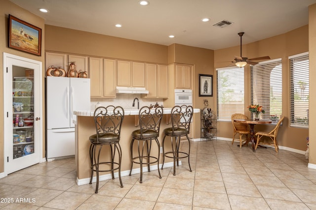 8698 E Preserve Way, Scottsdale, AZ 85266 - kitchen with white appliances, under cabinet range hood, light countertops, recessed lighting, and ceiling fan