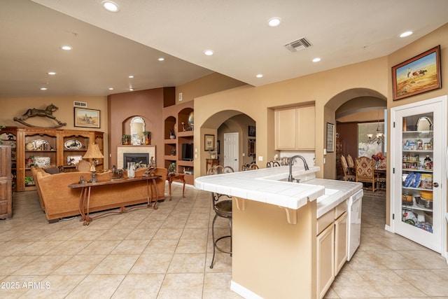 8698 E Preserve Way, Scottsdale, AZ 85266 - kitchen with tile countertops, arched walkways, white dishwasher, light tile patterned flooring, and recessed lighting