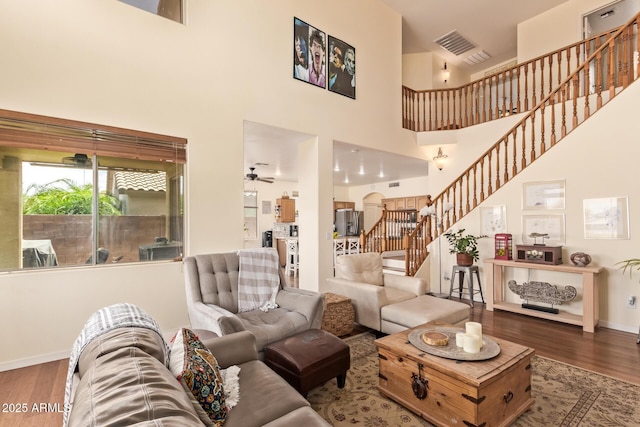 30013 N Candlewood Dr, San Tan Valley, AZ 85143 - living area featuring a towering ceiling, wood finished floors, baseboards, and stairs