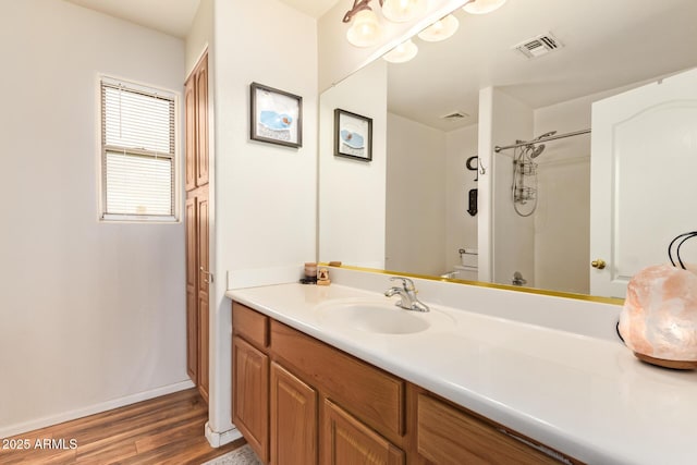 30013 N Candlewood Dr, San Tan Valley, AZ 85143 - bathroom featuring baseboards, visible vents, vanity, wood finished floors, and a shower