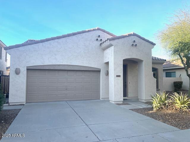 mediterranean / spanish-style home with a garage