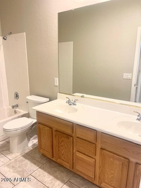 full bathroom with tile patterned floors, shower / washtub combination, toilet, and vanity