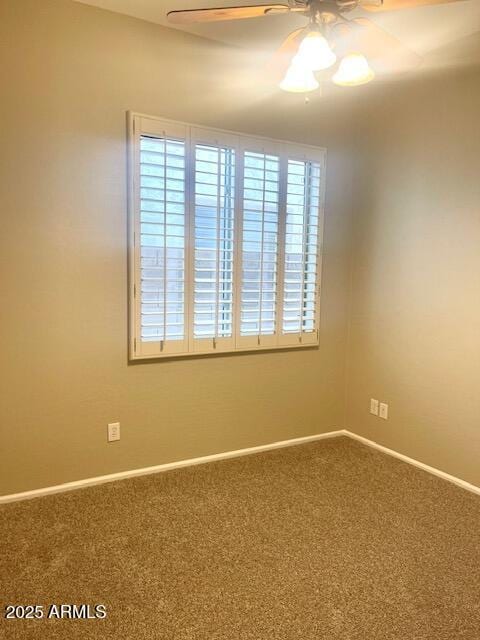 carpeted spare room with ceiling fan