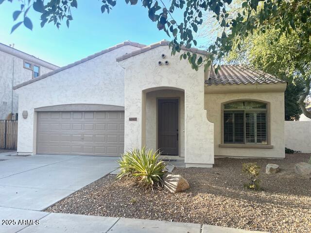 mediterranean / spanish-style home with a garage