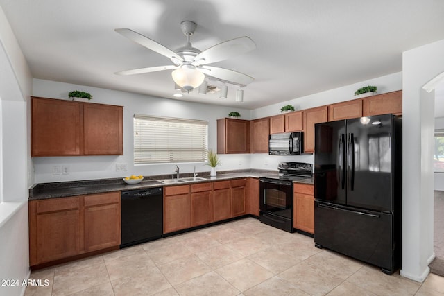 kitchen with light tile patterned floors, sink, ceiling fan, and black appliances