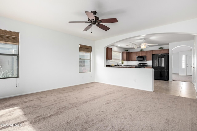 unfurnished living room with ceiling fan and plenty of natural light