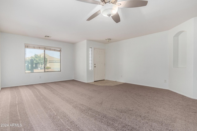 unfurnished room with light colored carpet and ceiling fan