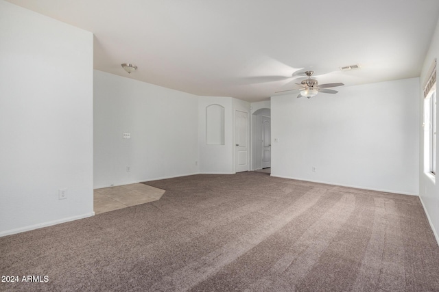 carpeted spare room featuring ceiling fan