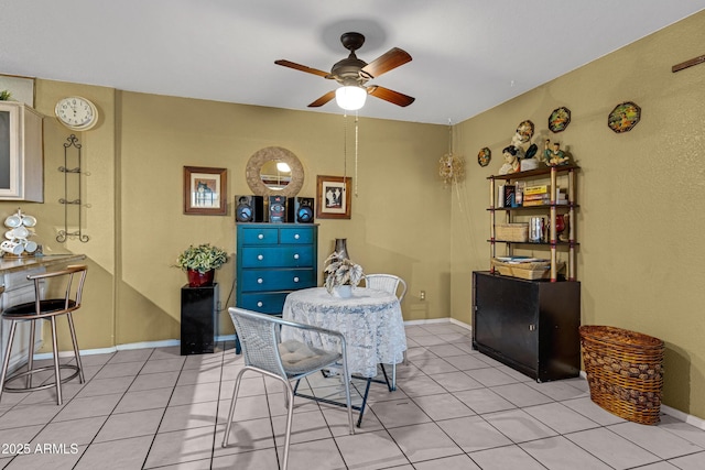 dining area featuring baseboards, a ceiling fan, and light tile patterned flooring