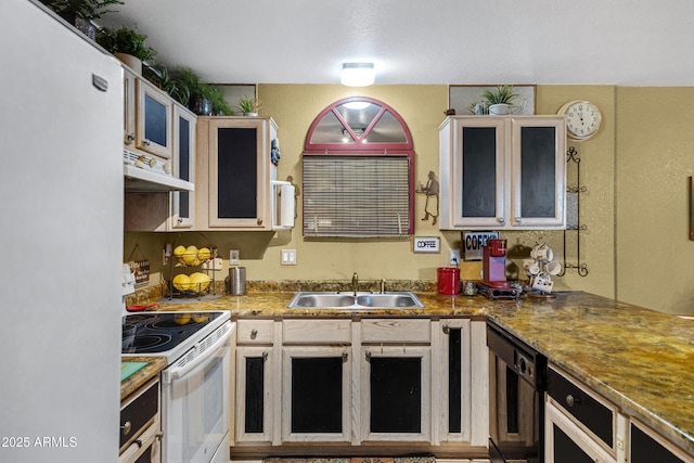 kitchen with under cabinet range hood, white electric range, a sink, freestanding refrigerator, and glass insert cabinets