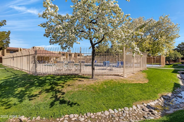 exterior space with a patio area, fence, and a community pool