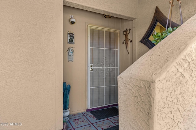 property entrance with stucco siding