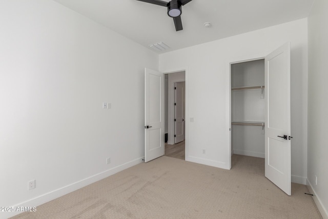 unfurnished bedroom with light carpet, ceiling fan, and a closet