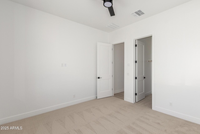 unfurnished bedroom featuring light carpet and ceiling fan