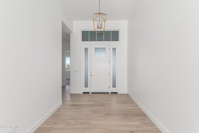 entryway featuring a chandelier and light hardwood / wood-style flooring