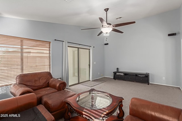 living room featuring ceiling fan, light carpet, and vaulted ceiling