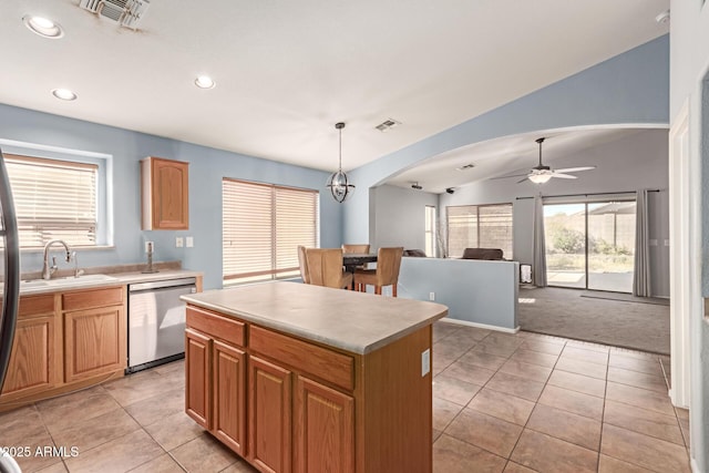 kitchen with dishwasher, a center island, sink, pendant lighting, and ceiling fan with notable chandelier