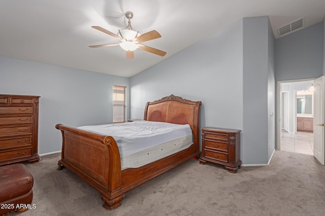 carpeted bedroom with ensuite bath, ceiling fan, and lofted ceiling