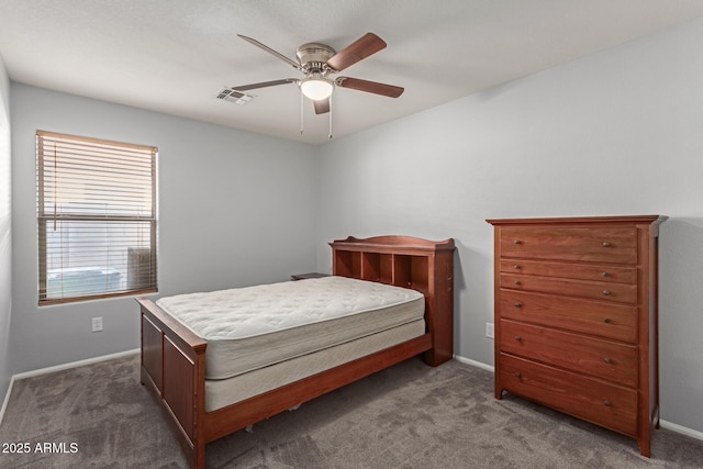 bedroom featuring ceiling fan and dark carpet