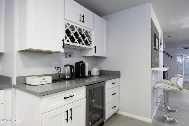 bar featuring white cabinets and beverage cooler