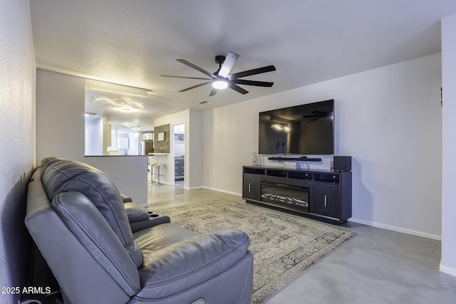 living room featuring concrete floors and ceiling fan