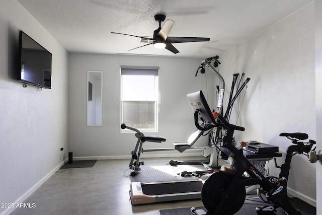 exercise area with ceiling fan and a textured ceiling