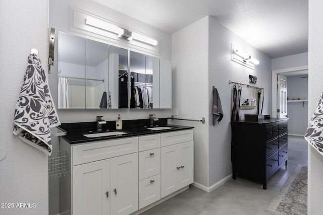 bathroom with vanity and concrete flooring