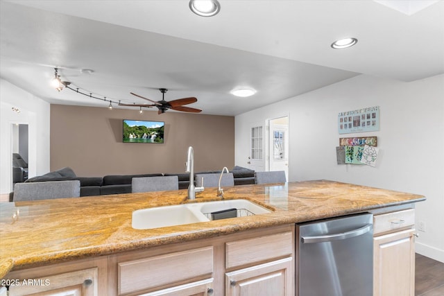 kitchen featuring dark wood-type flooring, light brown cabinetry, sink, dishwasher, and ceiling fan