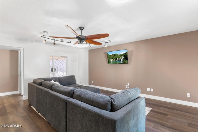 living room with dark wood-type flooring, ceiling fan, and track lighting