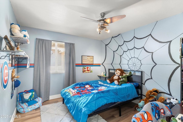 bedroom with light hardwood / wood-style flooring and ceiling fan