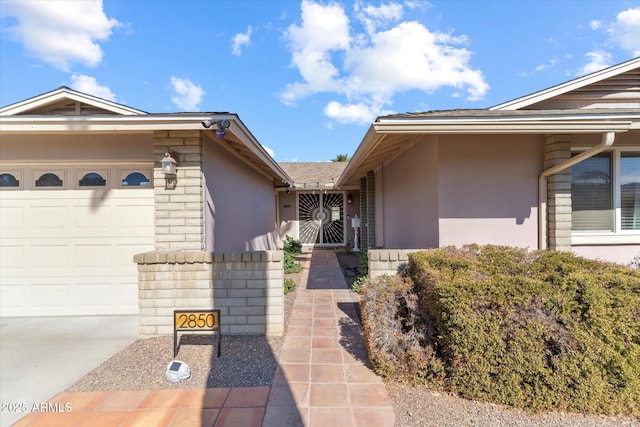 view of exterior entry with a garage