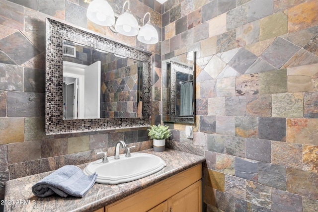 bathroom featuring vanity and decorative backsplash