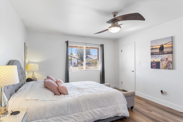 bedroom with hardwood / wood-style flooring and ceiling fan