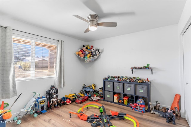 rec room with hardwood / wood-style flooring and ceiling fan