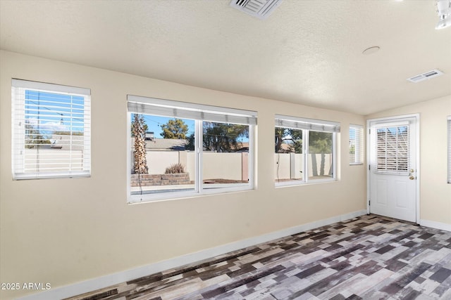 unfurnished sunroom with vaulted ceiling and plenty of natural light