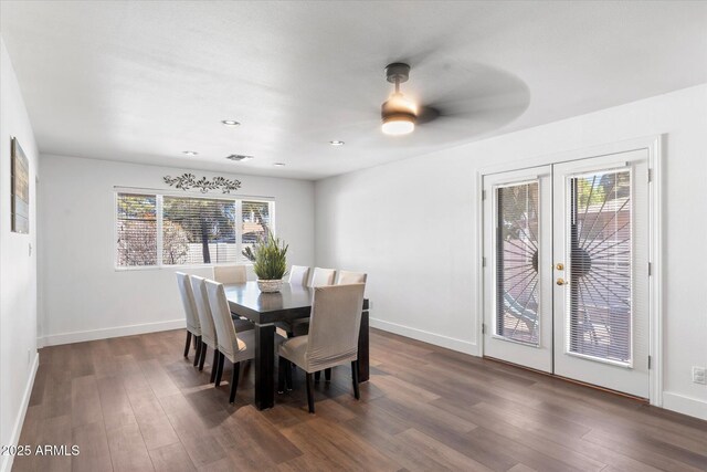 dining space with dark wood-type flooring, ceiling fan, and french doors