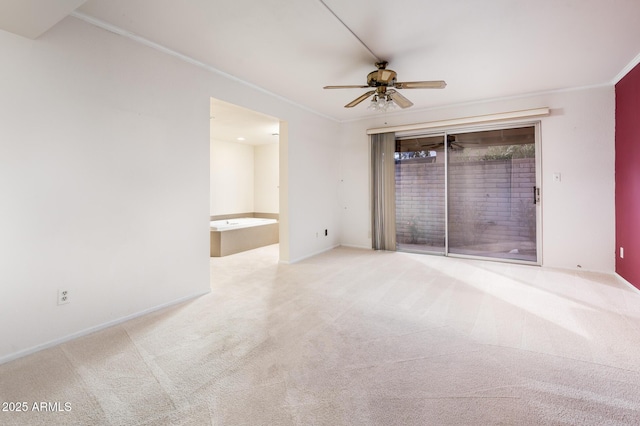 carpeted empty room with crown molding and ceiling fan