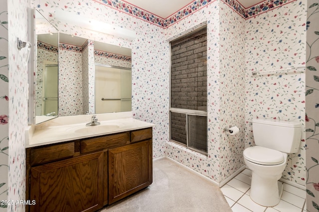 bathroom featuring vanity, tile patterned flooring, and toilet