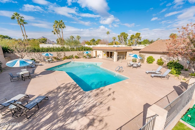 view of swimming pool featuring a patio area and a bar